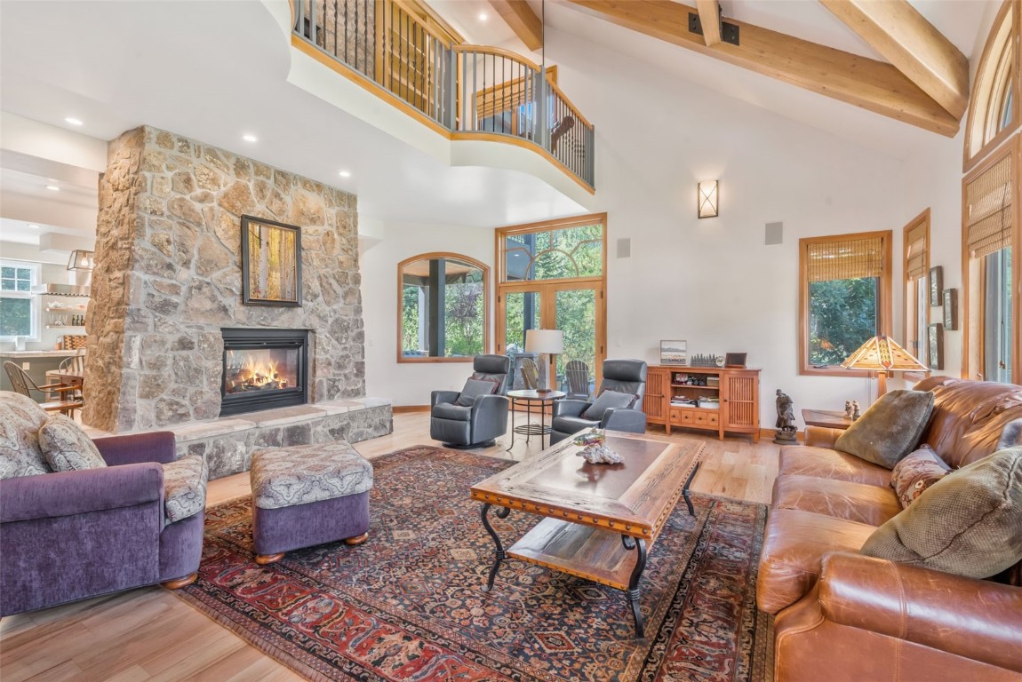 2911 Inverness Way Steamboat Springs, CO 80487 - Photo 9 of 43 a living room with furniture fireplace and a large window