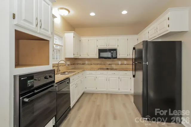 a kitchen with a refrigerator stove and sink