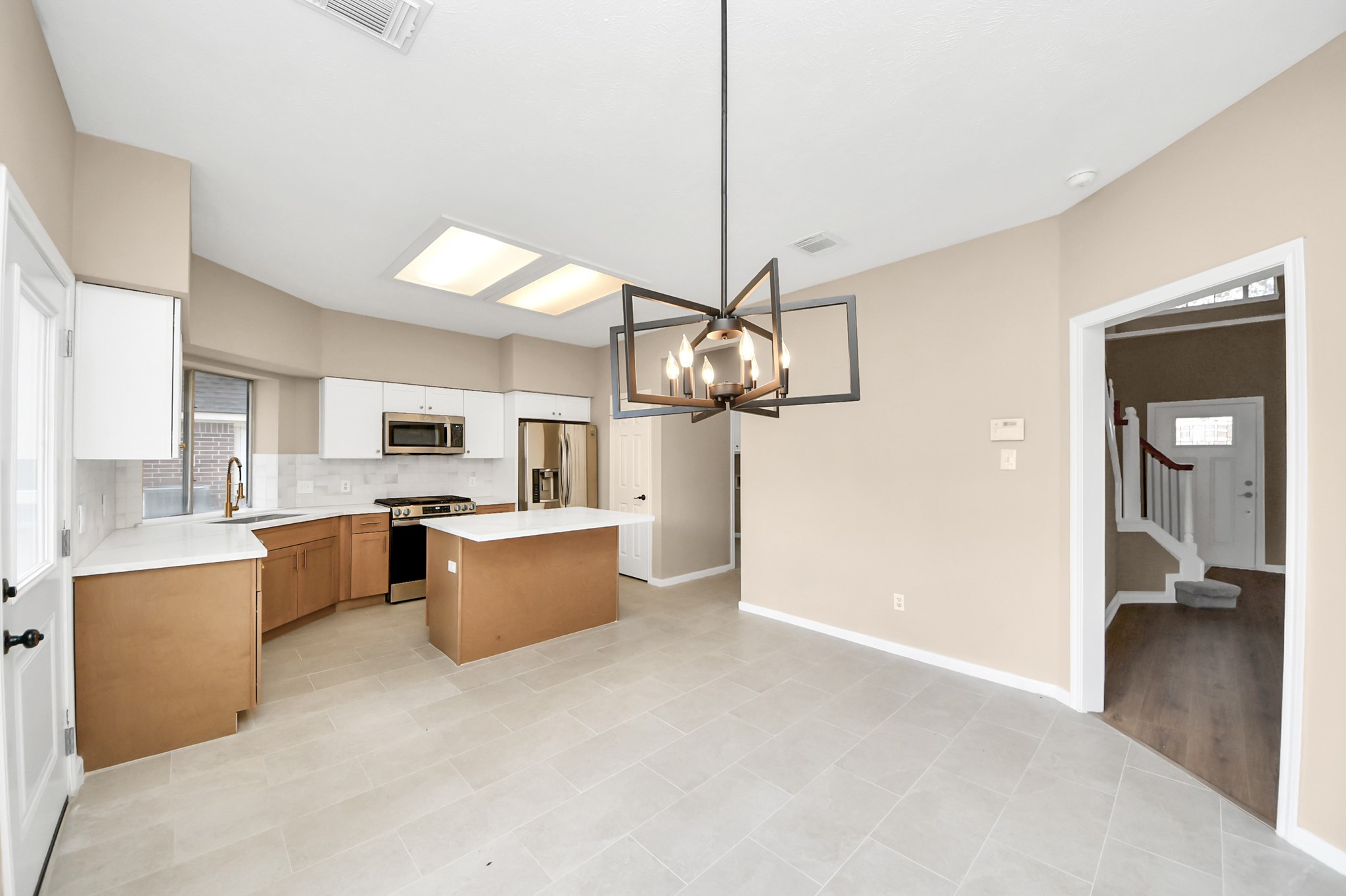 19030 Keyturn Lane Humble, TX 77346 - Photo 13 of 50 a large kitchen with a lot of cabinets and refrigerator
