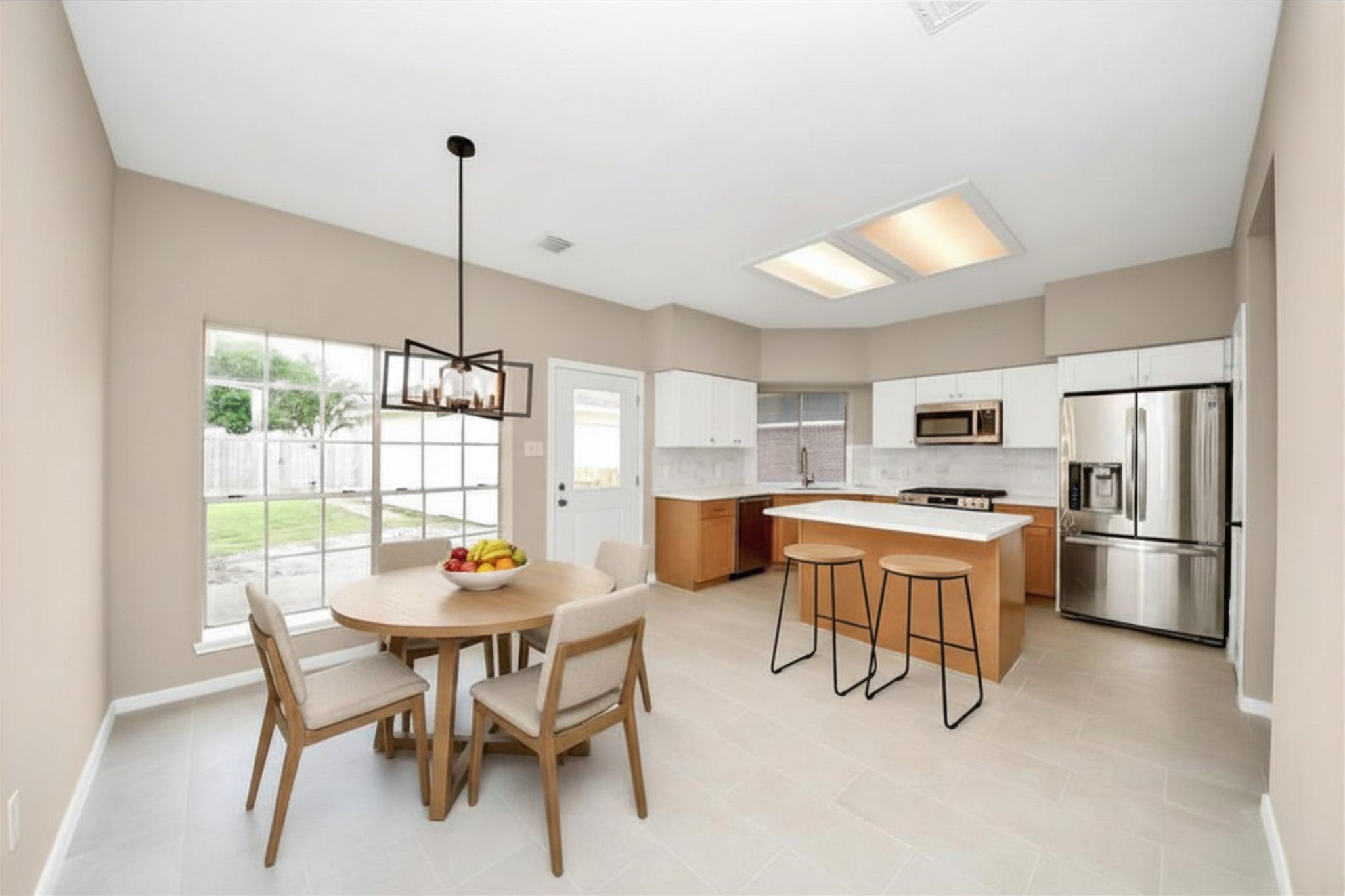 19030 Keyturn Lane Humble, TX 77346 - Photo 14 of 50 a dining room with stainless steel appliances a dining table chairs and a refrigerator