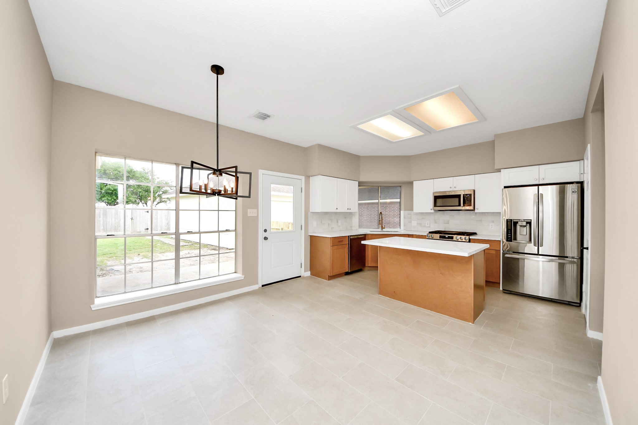 19030 Keyturn Lane Humble, TX 77346 - Photo 15 of 50 a open kitchen with stainless steel appliances granite countertop a refrigerator a sink dishwasher a oven with white cabinets and countertops