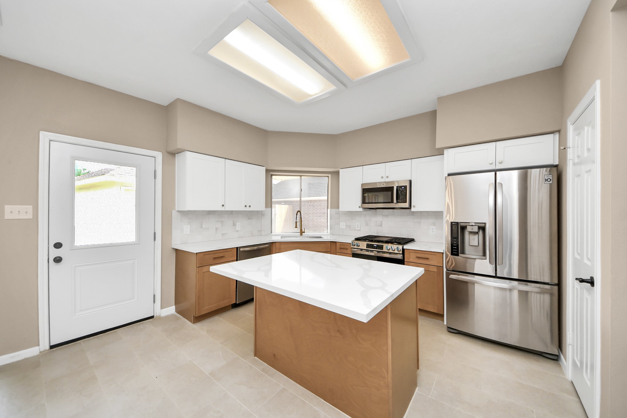 19030 Keyturn Lane Humble, TX 77346 - Photo 16 of 50 a kitchen with stainless steel appliances a refrigerator a stove a sink and a refrigerator