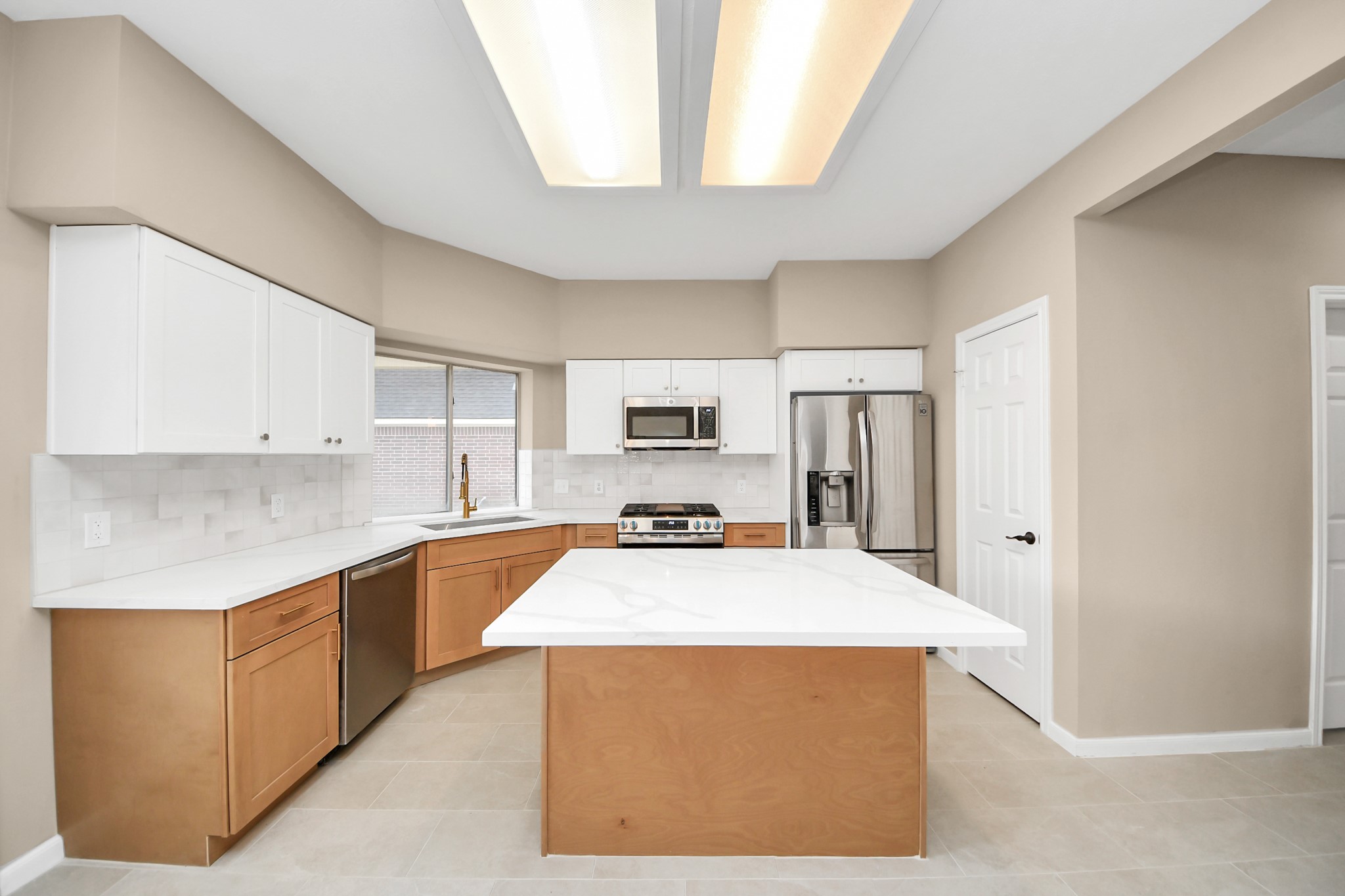 19030 Keyturn Lane Humble, TX 77346 - Photo 17 of 50 a kitchen with stainless steel appliances a refrigerator a stove and white cabinets
