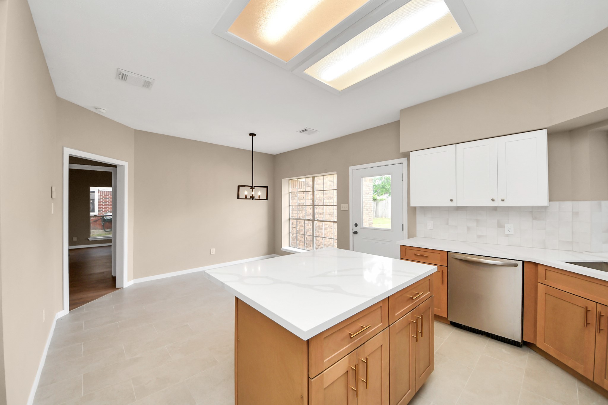 19030 Keyturn Lane Humble, TX 77346 - Photo 19 of 50 a kitchen with a stove a sink a refrigerator and white cabinets