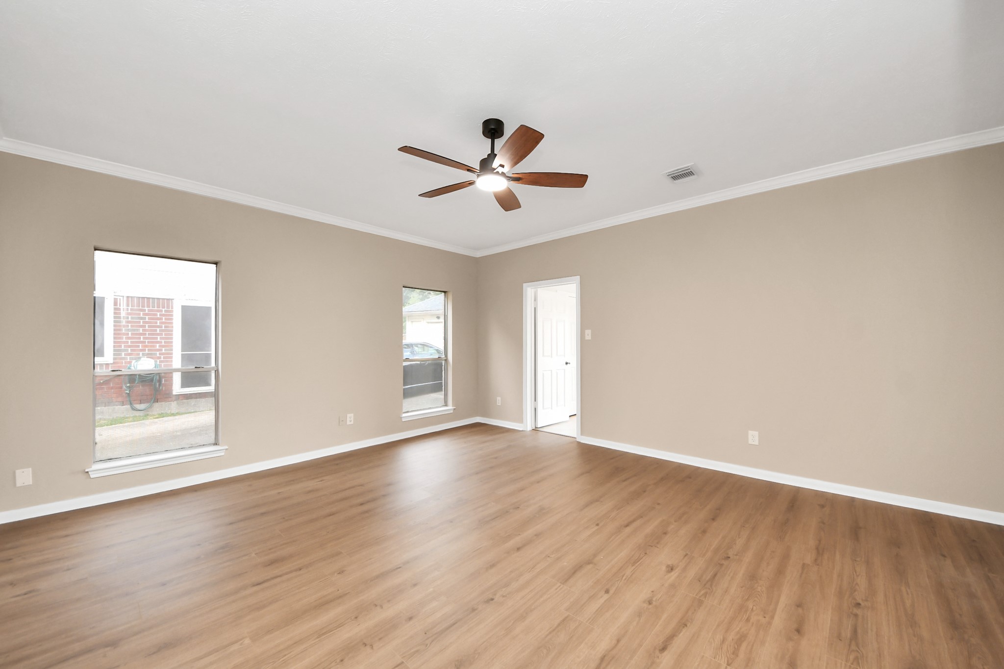 19030 Keyturn Lane Humble, TX 77346 - Photo 20 of 50 an empty room with wooden floor chandelier fan and windows