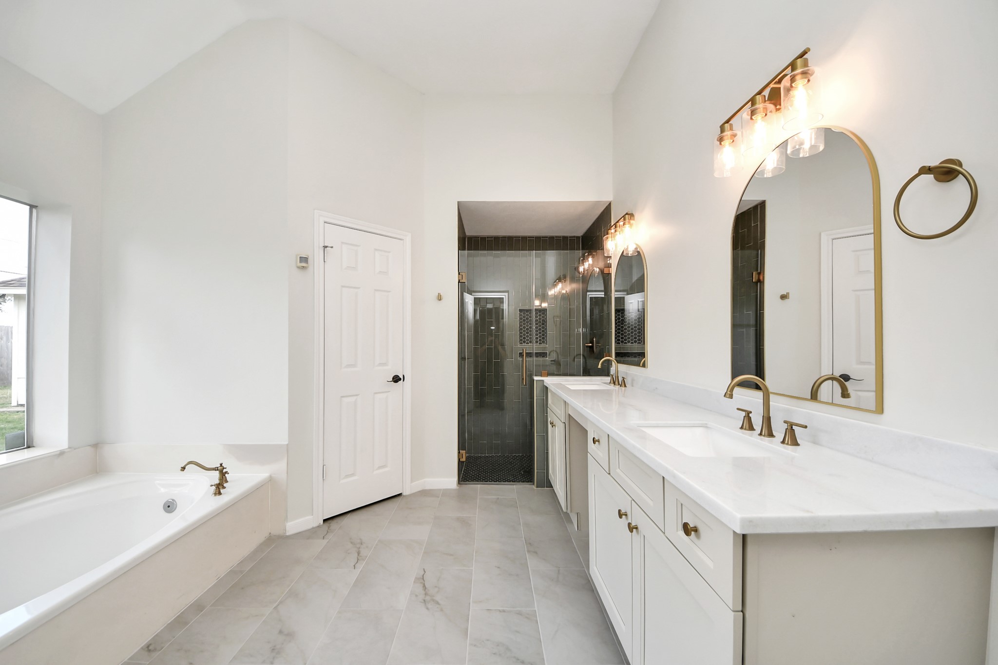 19030 Keyturn Lane Humble, TX 77346 - Photo 23 of 50 a spacious bathroom with a double vanity sink mirror double and bathtub