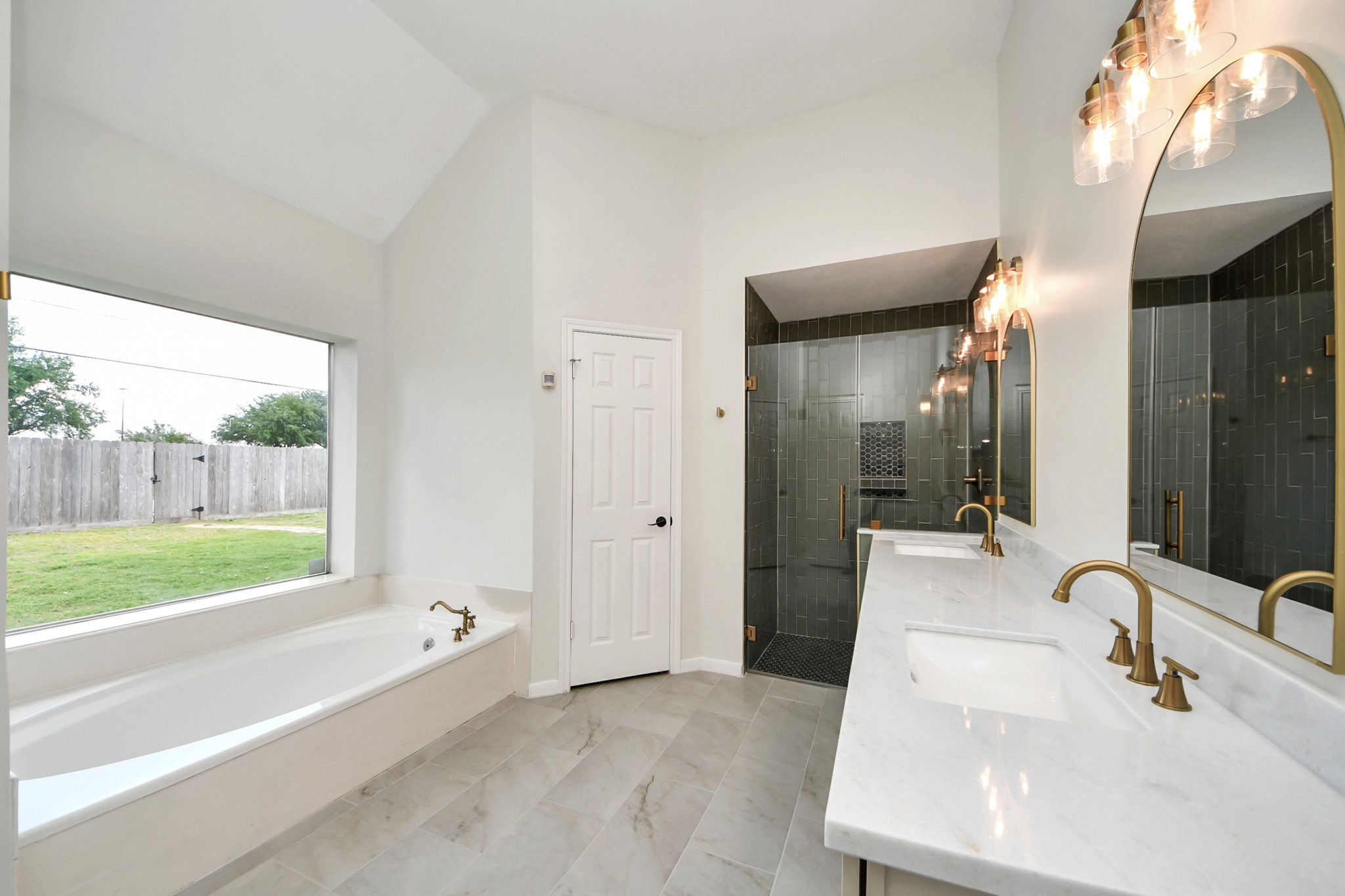19030 Keyturn Lane Humble, TX 77346 - Photo 24 of 50 a bathroom with a tub sink and mirror