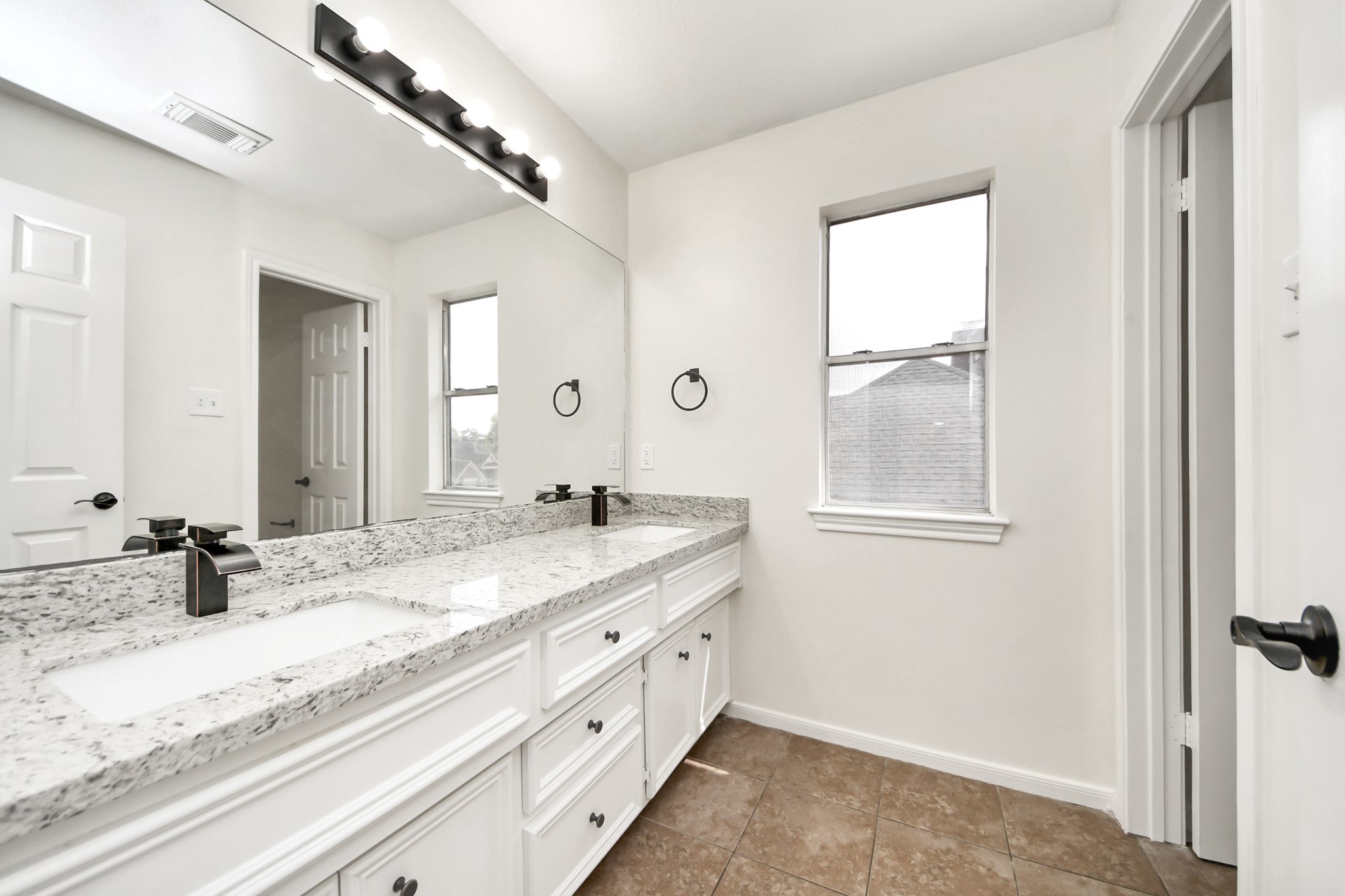 19030 Keyturn Lane Humble, TX 77346 - Photo 38 of 50 a bathroom with a granite countertop sink mirror and vanity