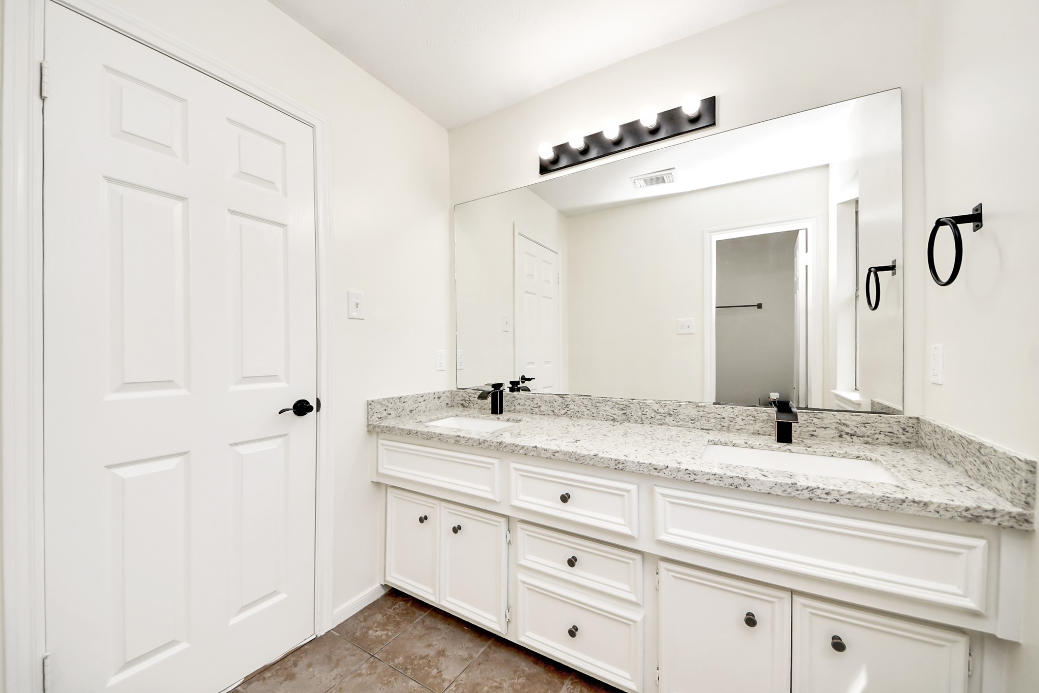 19030 Keyturn Lane Humble, TX 77346 - Photo 39 of 50 a bathroom with a granite countertop sink vanity and mirror