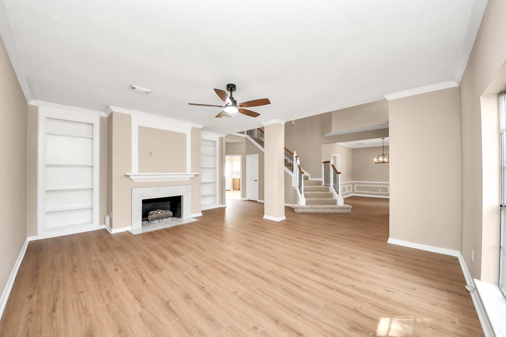 19030 Keyturn Lane Humble, TX 77346 - Photo 4 of 50 a view of empty room with wooden floor fireplace and windows