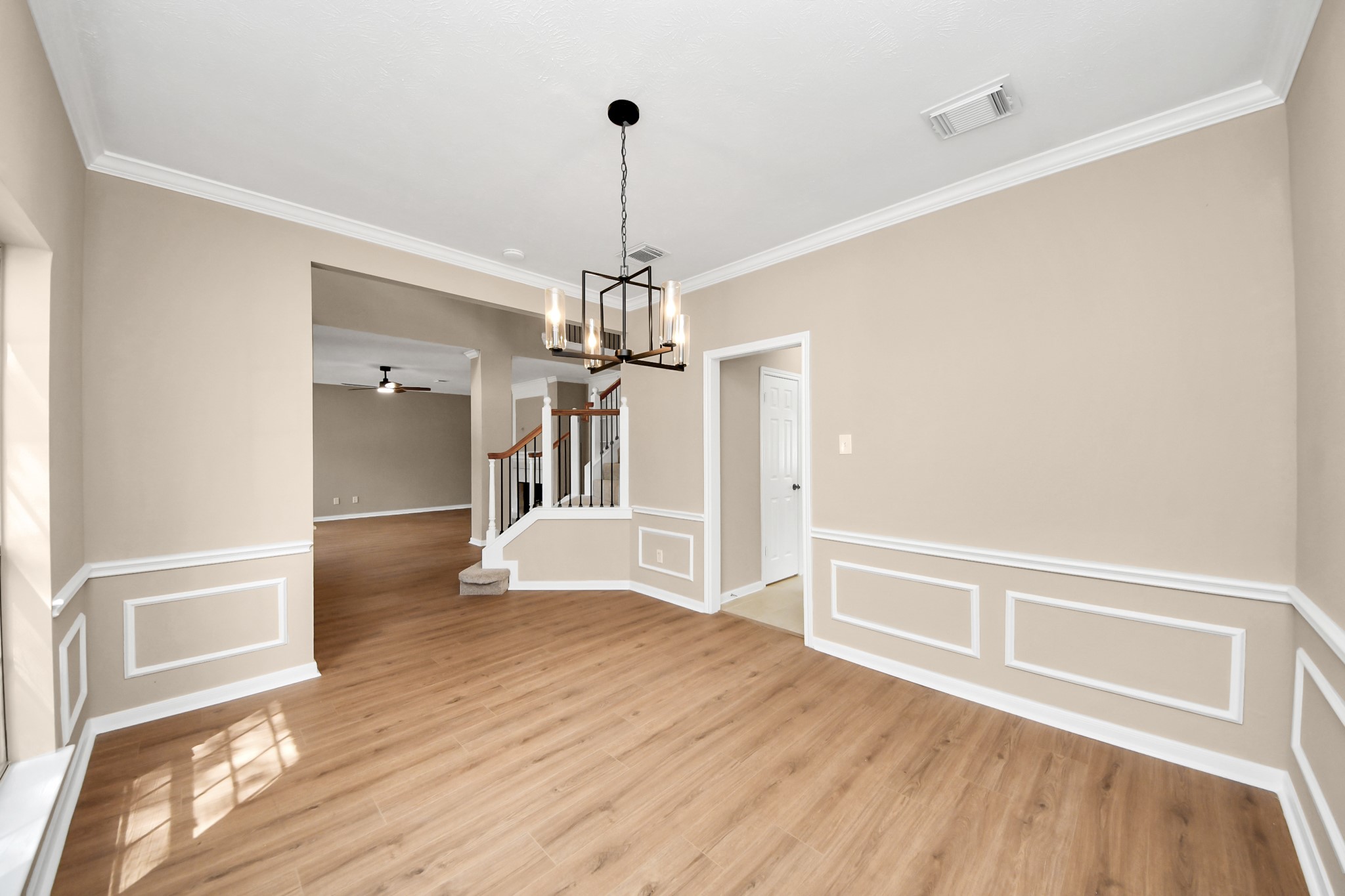 19030 Keyturn Lane Humble, TX 77346 - Photo 9 of 50 a view of an empty room with wooden floor kitchen view and a window