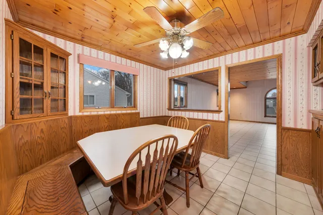 a view of a dining room with furniture and chandelier