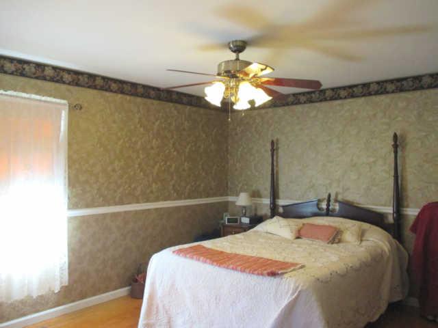 3280 Bethel Road Pulaski, TN 38478 - Photo 13 of 20 a bedroom with a bed and a chandelier