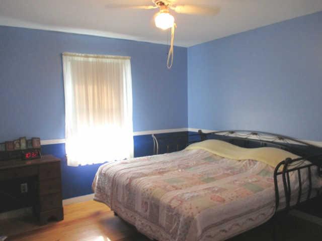 3280 Bethel Road Pulaski, TN 38478 - Photo 17 of 20 a bedroom with a bed and a chandelier