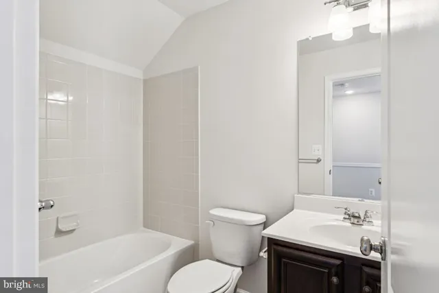 a bathroom with a sink toilet vanity and tub