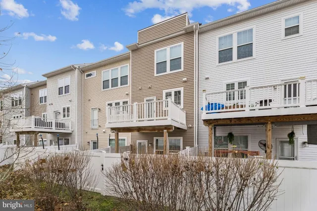 a front view of a building with a garden