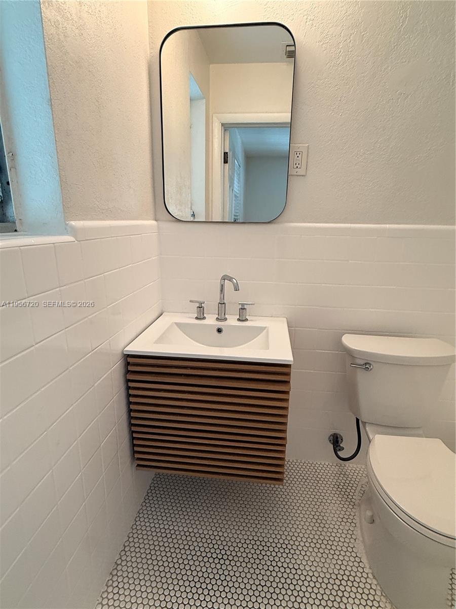 2538 Southwest 11th Street, Unit 2 Miami, FL 33135 - Photo 12 of 14 a bathroom with a sink a toilet and mirror
