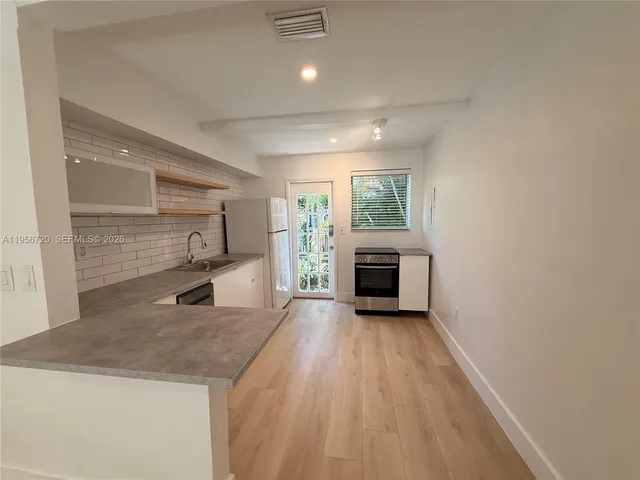 a view of a kitchen with a sink cabinets and a wooden floor