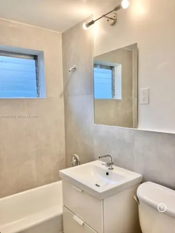 a bathroom with a sink a toilet and mirror