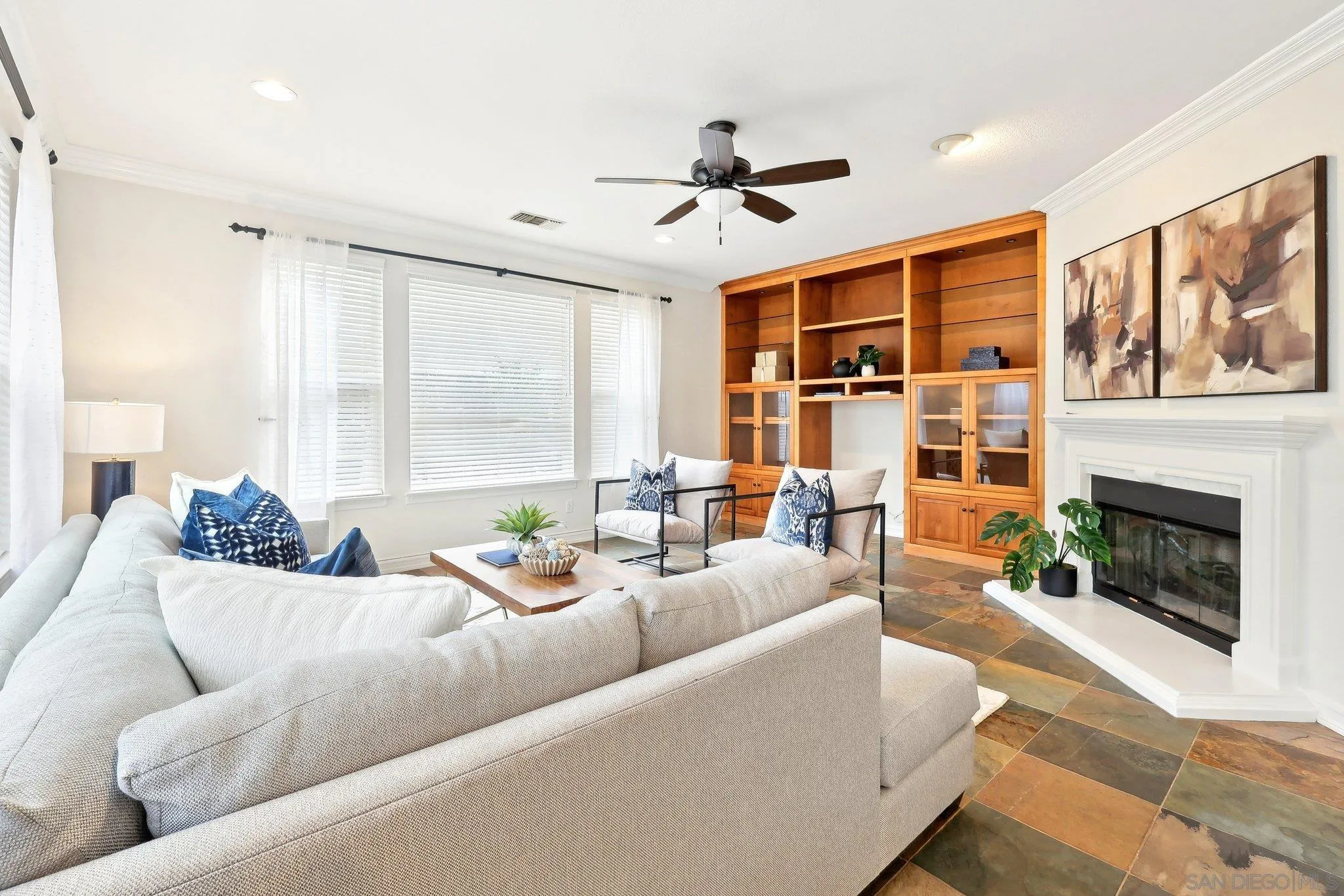 11781 Treadwell Drive Poway, CA 92064 - Photo 19 of 63 a living room with furniture ceiling fan and a fireplace