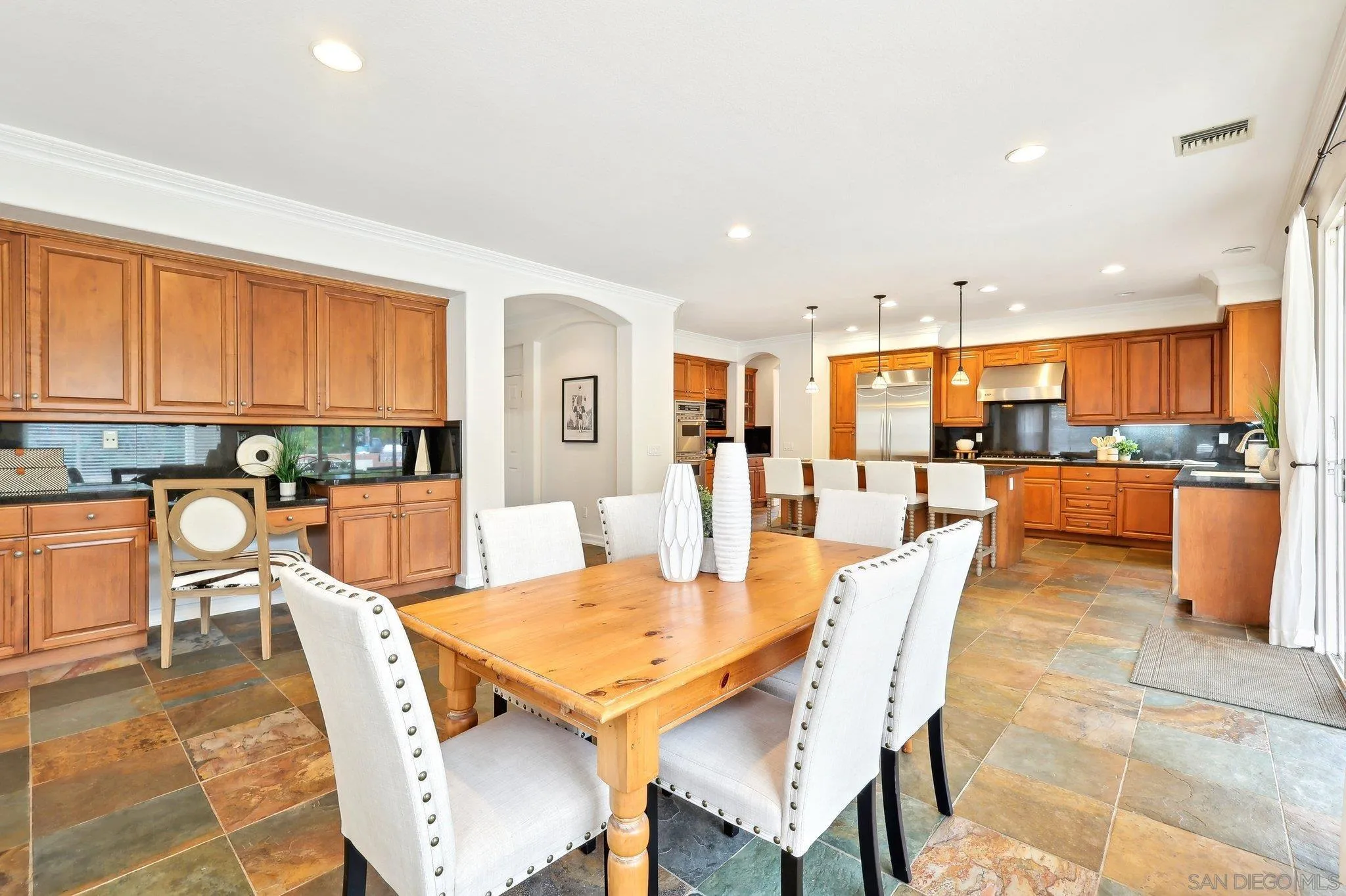11781 Treadwell Drive Poway, CA 92064 - Photo 22 of 63 a dining room with stainless steel appliances a table and chairs