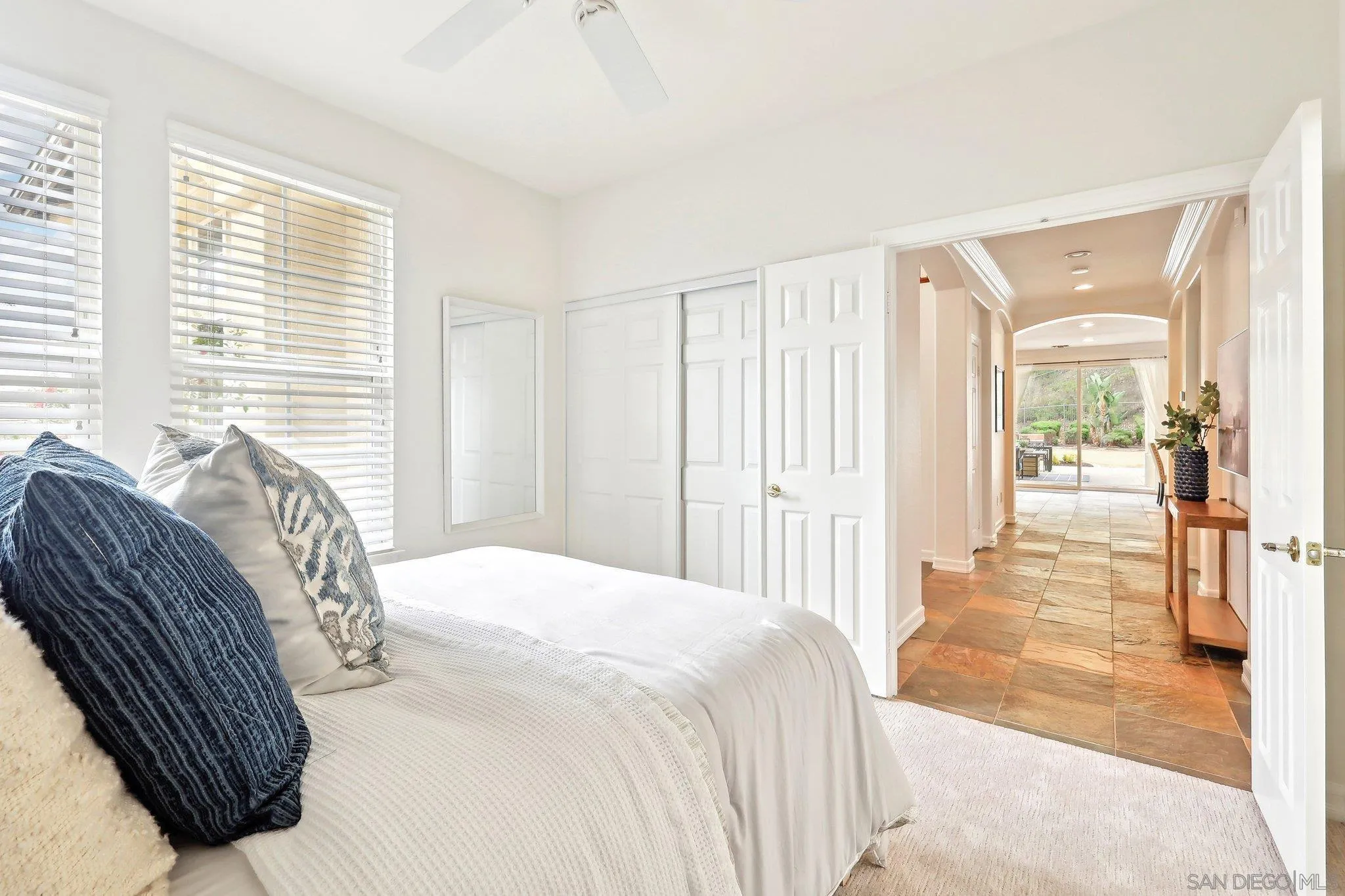 11781 Treadwell Drive Poway, CA 92064 - Photo 28 of 63 a bedroom with a bed a mirror and a large window