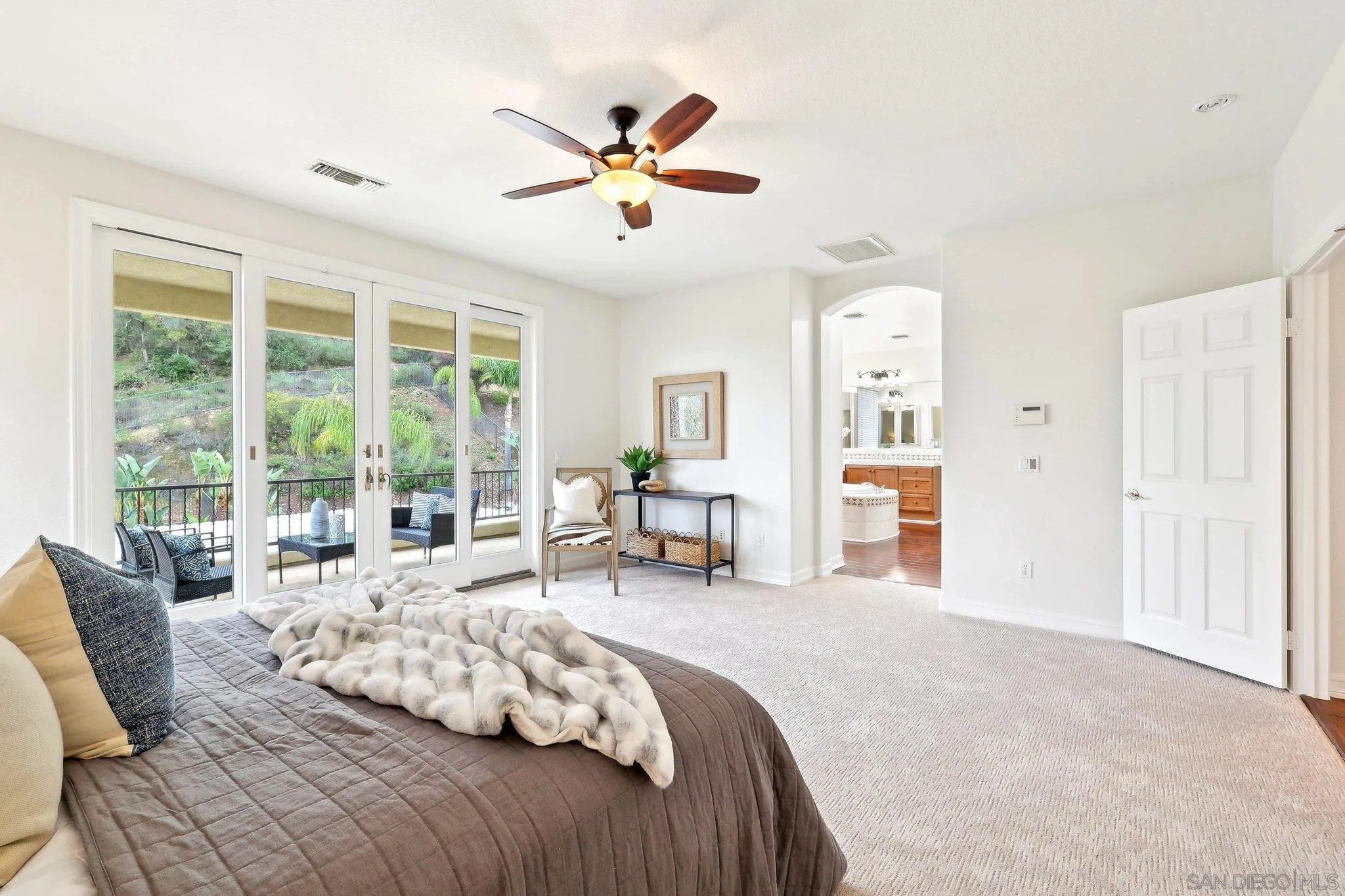 11781 Treadwell Drive Poway, CA 92064 - Photo 33 of 63 a spacious bedroom with a large bed and a large window