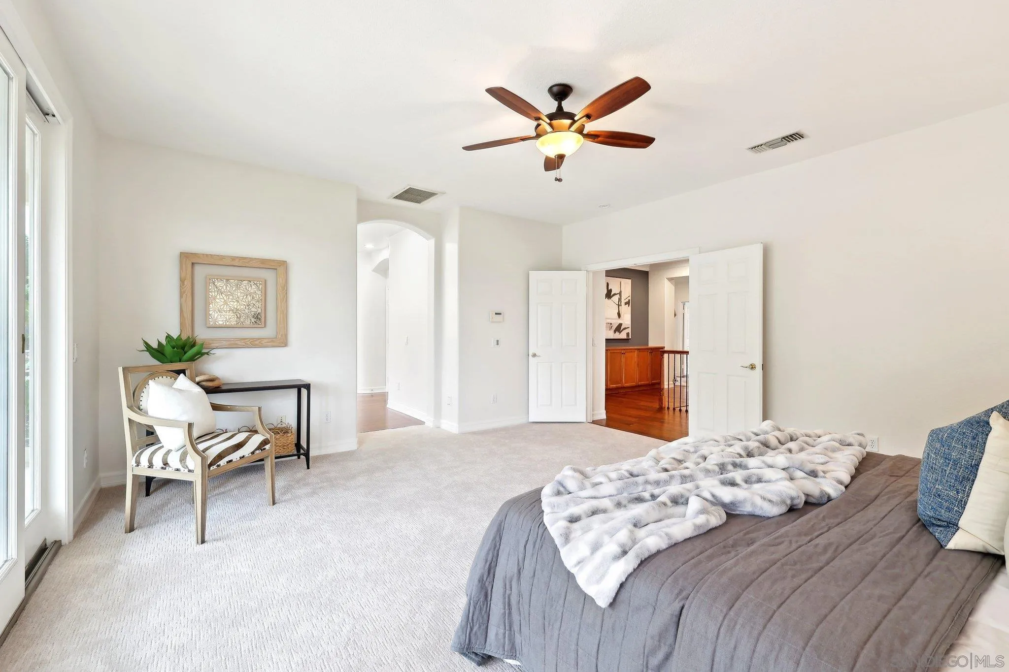 11781 Treadwell Drive Poway, CA 92064 - Photo 36 of 63 a bedroom with a bed and a chandelier