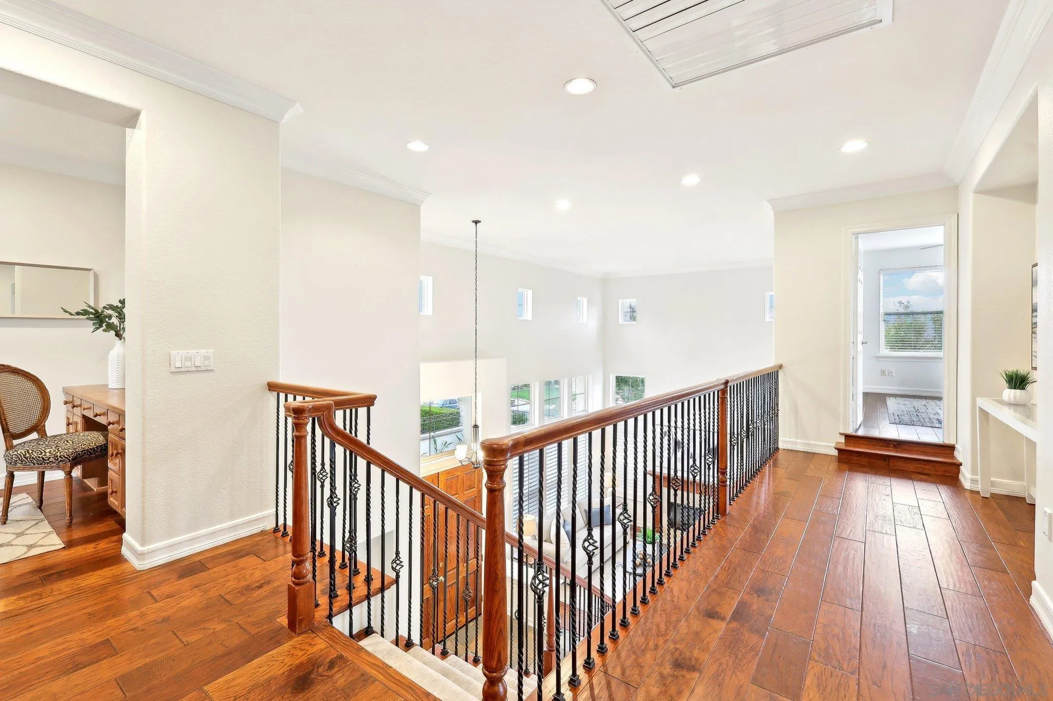 11781 Treadwell Drive Poway, CA 92064 - Photo 43 of 63 a view of a hallway with wooden floor and windows