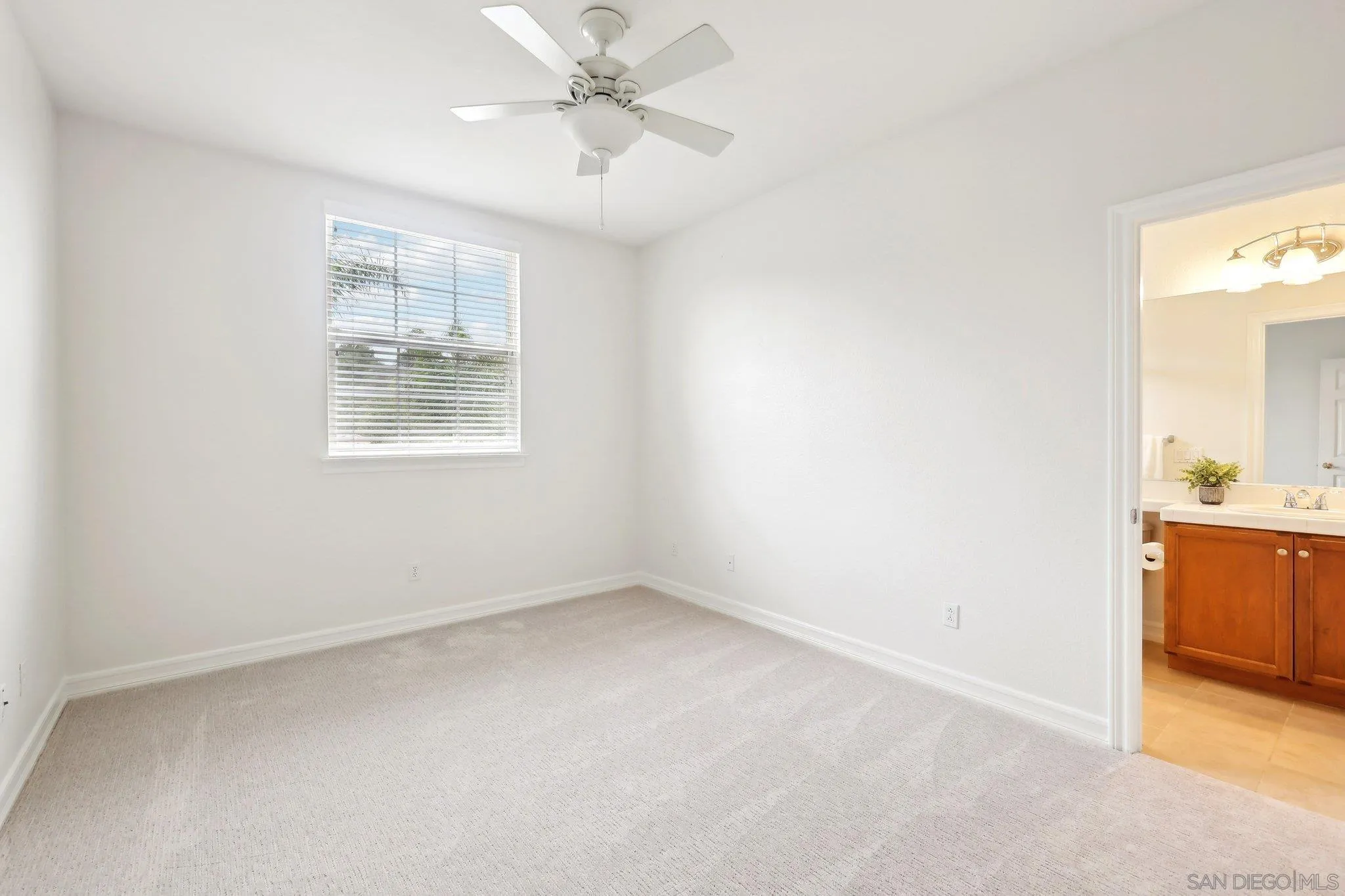 11781 Treadwell Drive Poway, CA 92064 - Photo 46 of 63 an empty room with chandelier fan and wooden floor