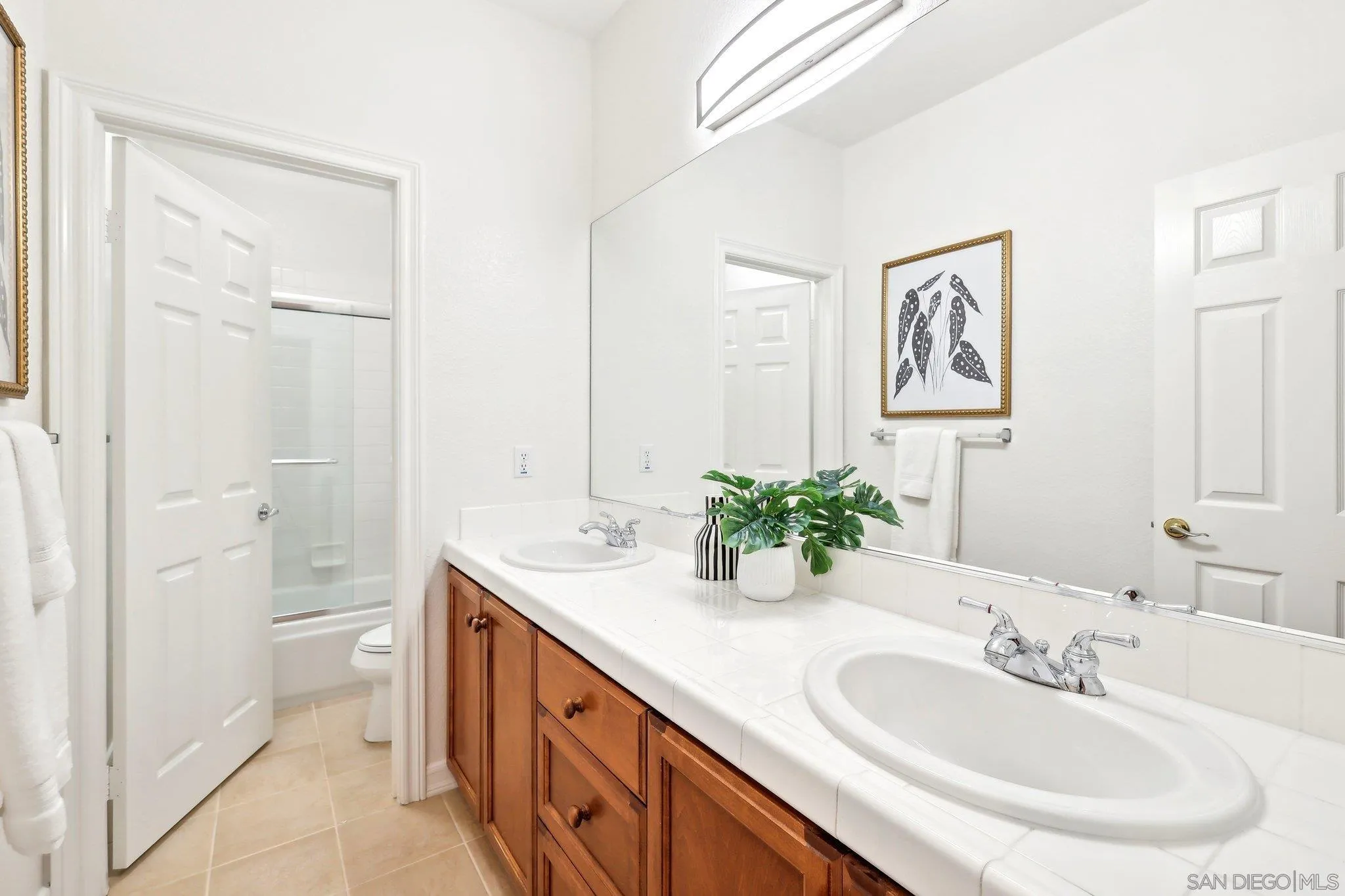 11781 Treadwell Drive Poway, CA 92064 - Photo 50 of 63 a bathroom with a double vanity sink mirror and a bathtub