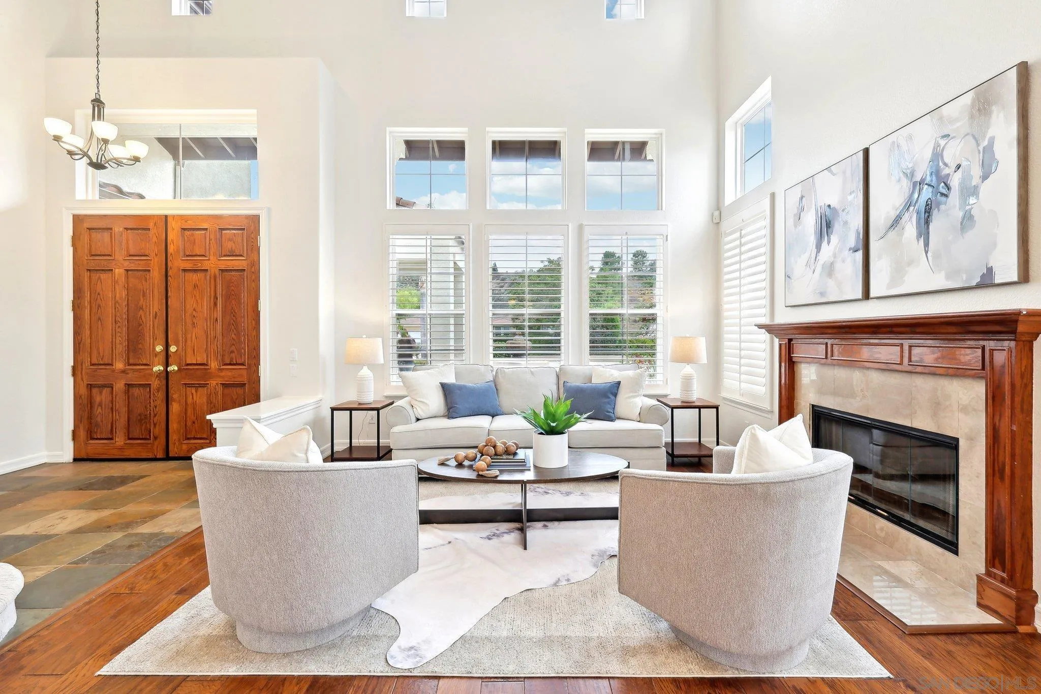 11781 Treadwell Drive Poway, CA 92064 - Photo 5 of 63 a living room with couches potted plants and a fireplace
