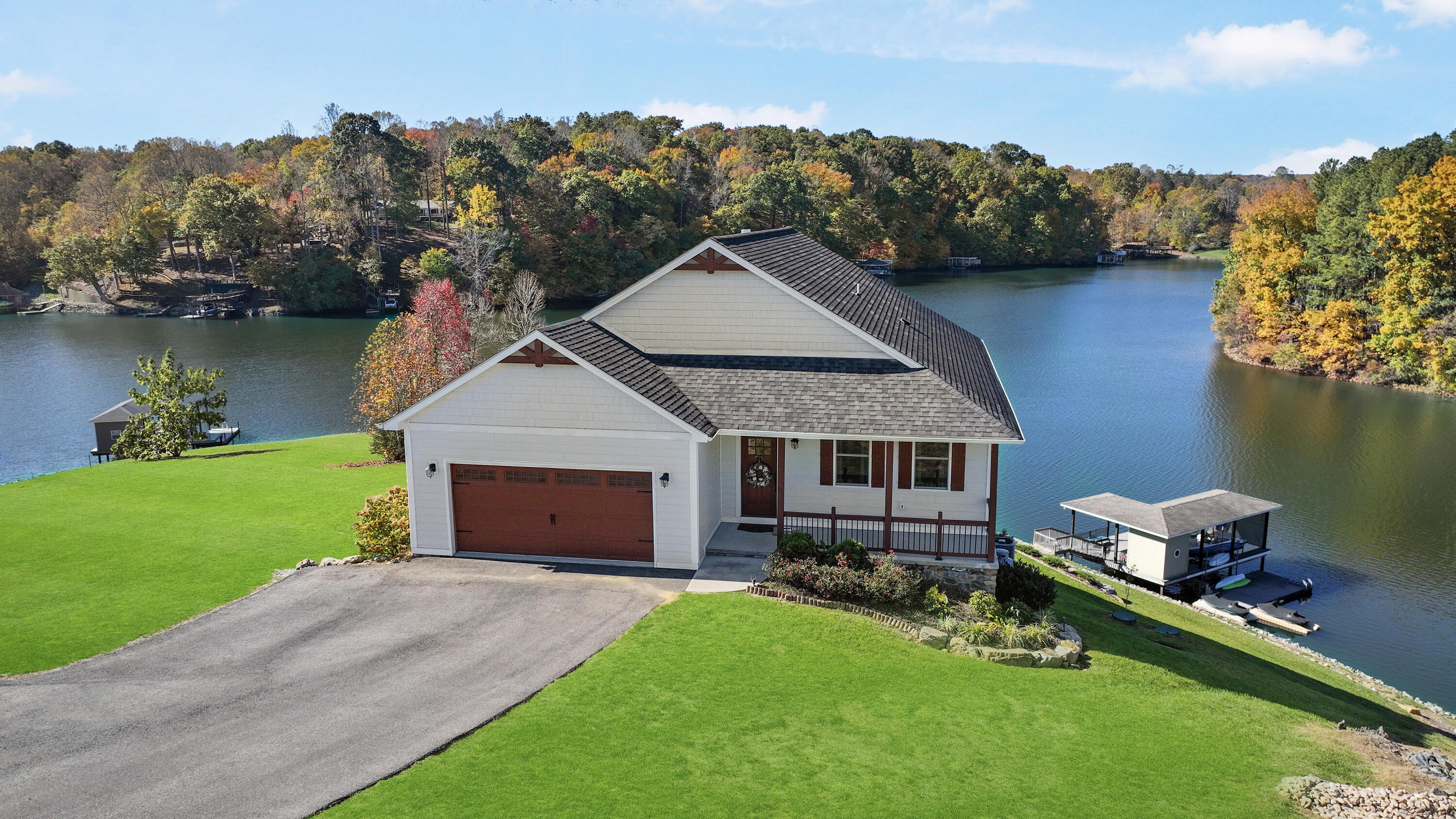 an aerial view of a house with swimming pool and a yard