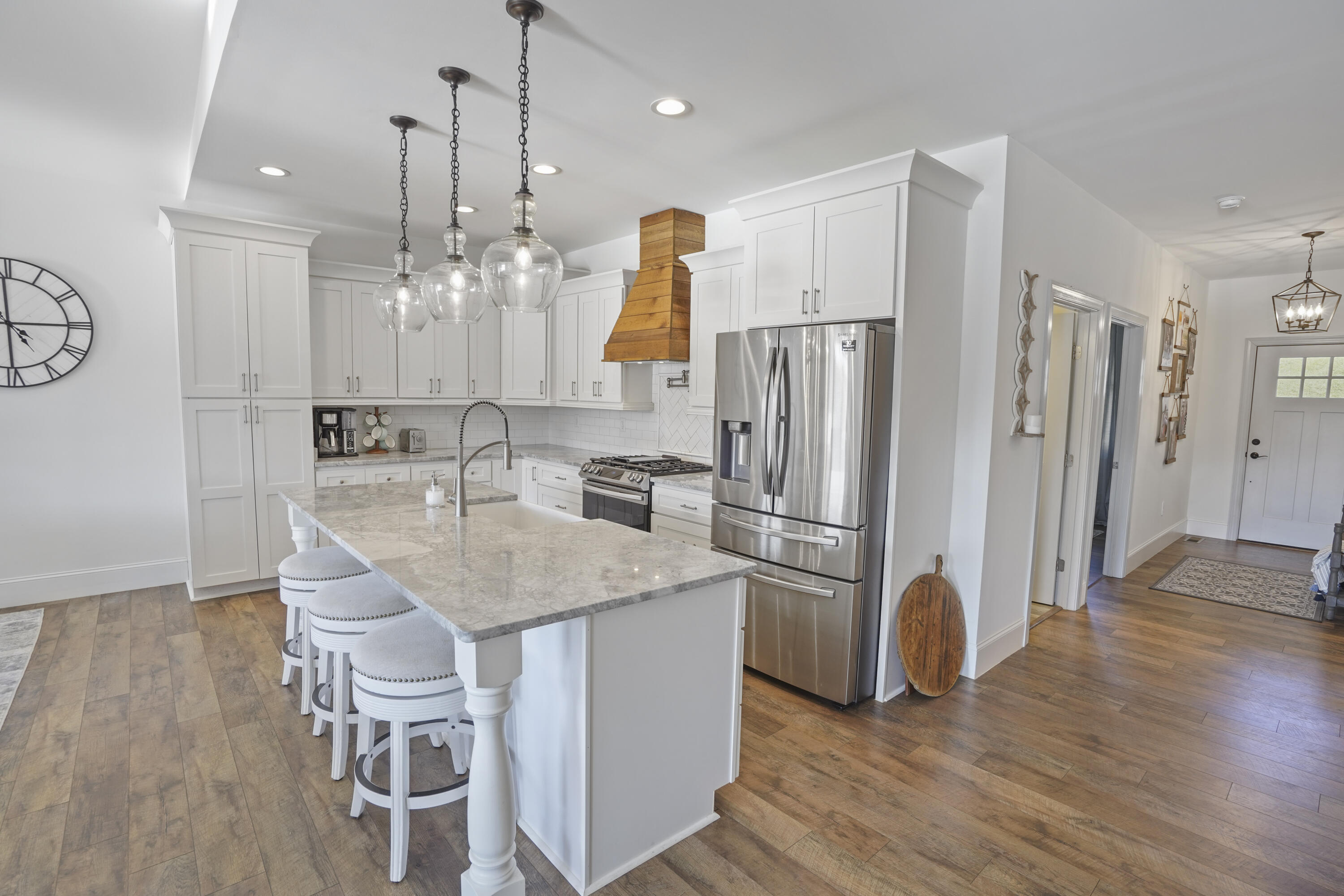 11 Old Point Road Moneta, VA 24121 - Photo 10 of 49 a kitchen with stainless steel appliances granite countertop a refrigerator a sink a stove and a wooden floors