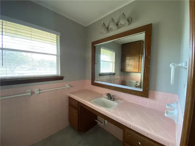 a bathroom with a sink and a window