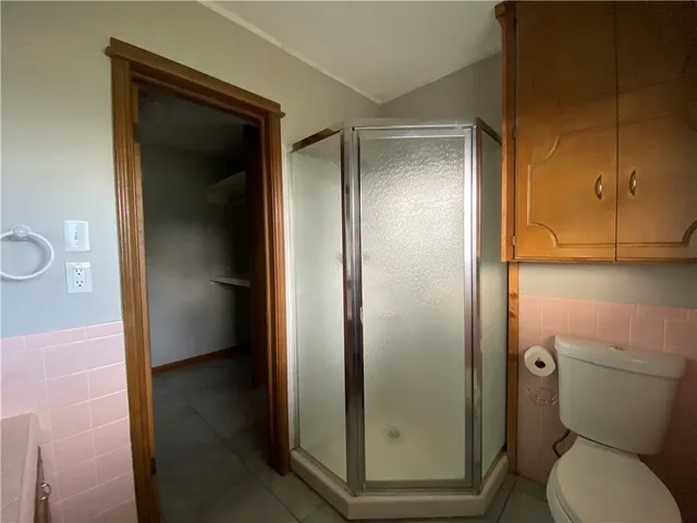 a bathroom with a glass door shower