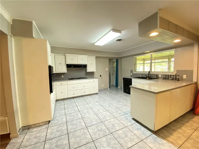 a kitchen with stainless steel appliances a refrigerator sink and cabinets