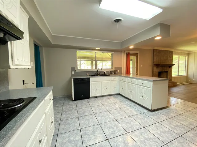 a large kitchen with a stove a sink dishwasher and a stove