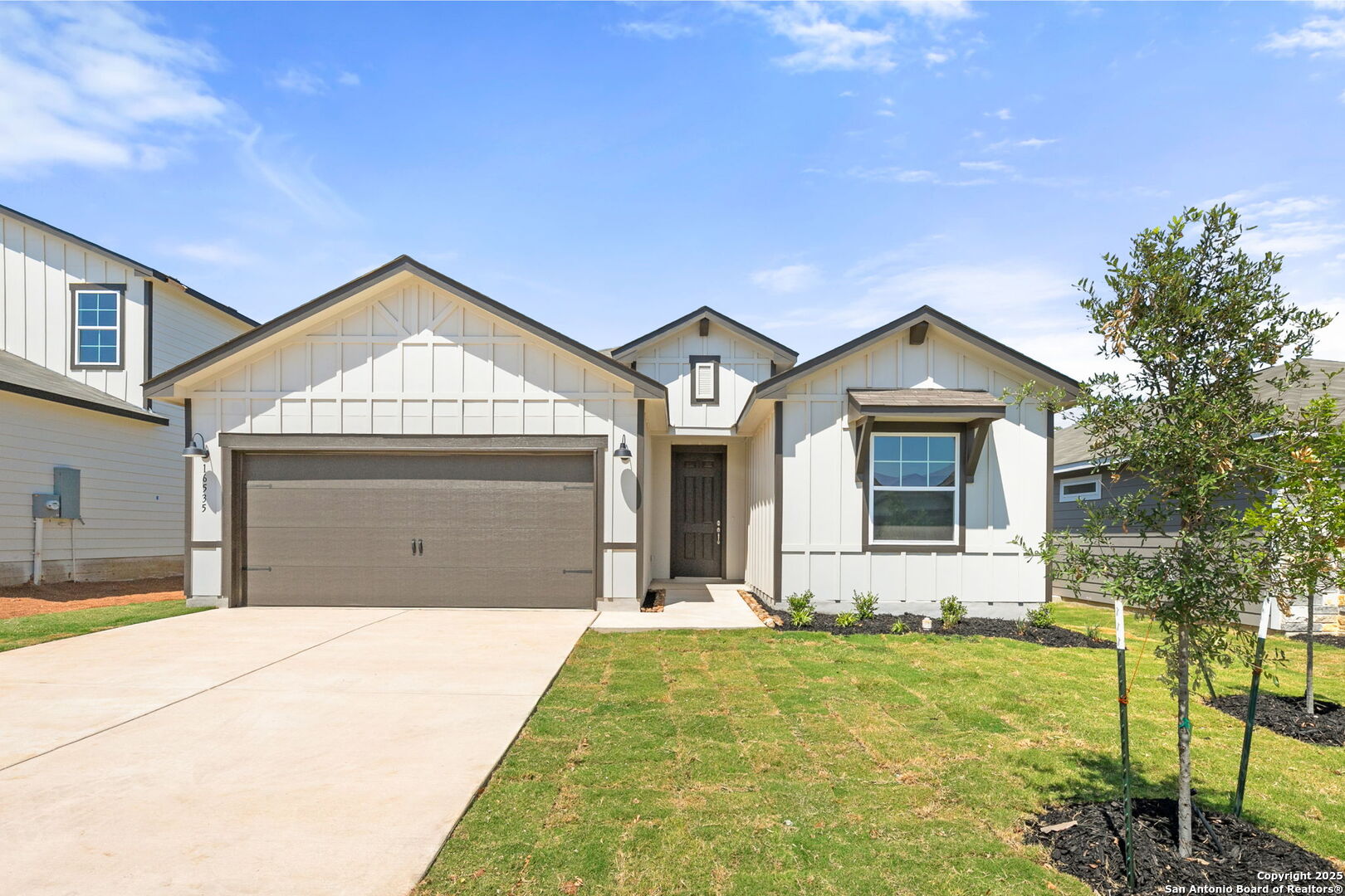 16535 Rosemary Ridge Elmendorf, TX 78112 - Photo 1 of 1 a front view of a house with garden
