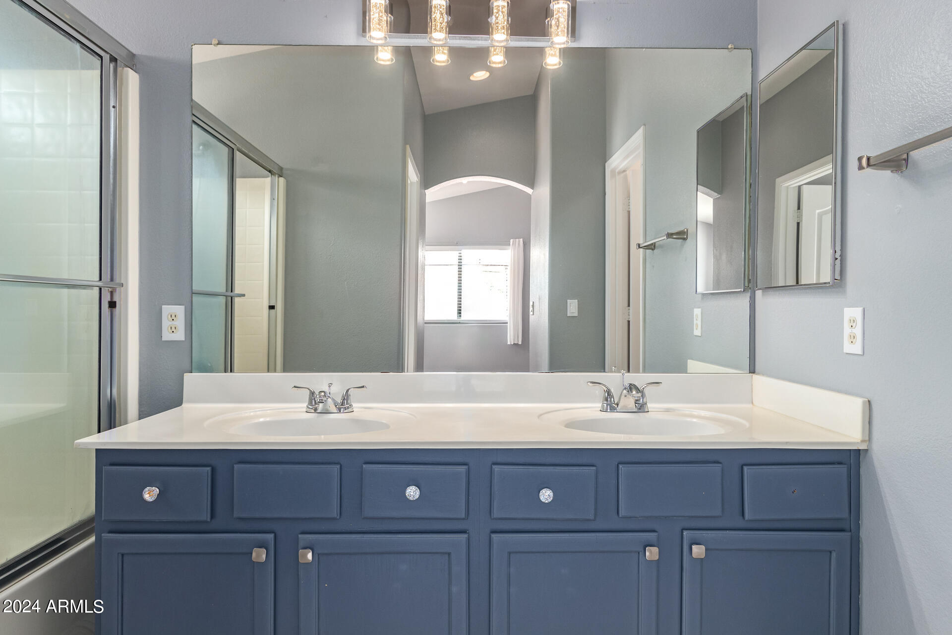 4333 South Rim Court Gilbert, AZ 85297 - Photo 13 of 77 a bathroom with a double vanity sink and a mirror