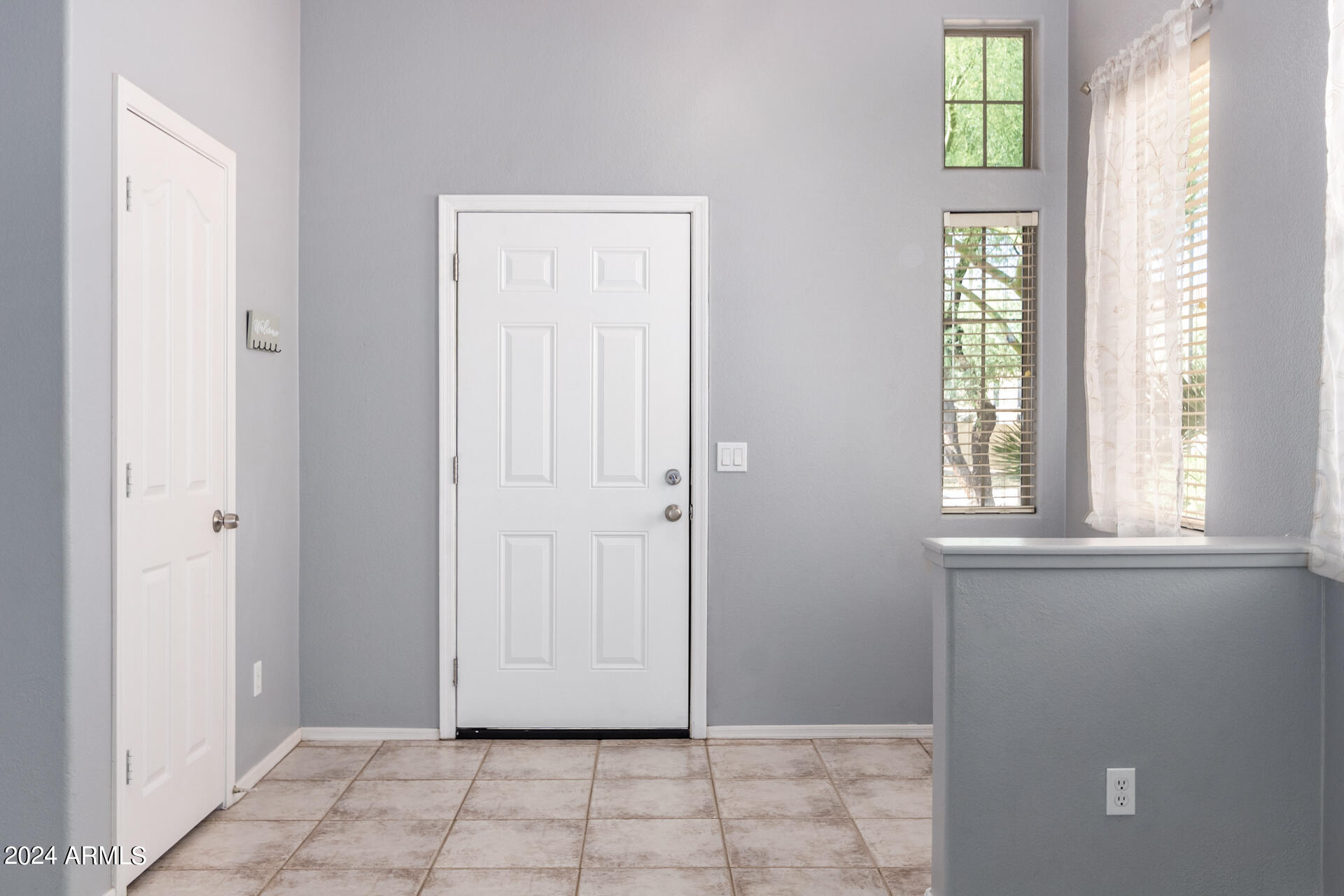 4333 South Rim Court Gilbert, AZ 85297 - Photo 3 of 77 a view of an entryway with wooden floor and windows