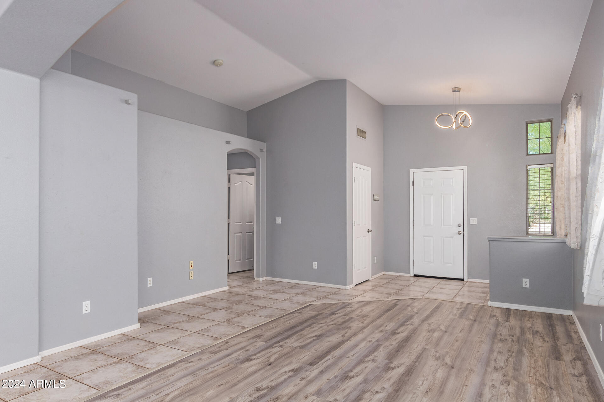 4333 South Rim Court Gilbert, AZ 85297 - Photo 5 of 77 a view of a livingroom with wooden floor and windows