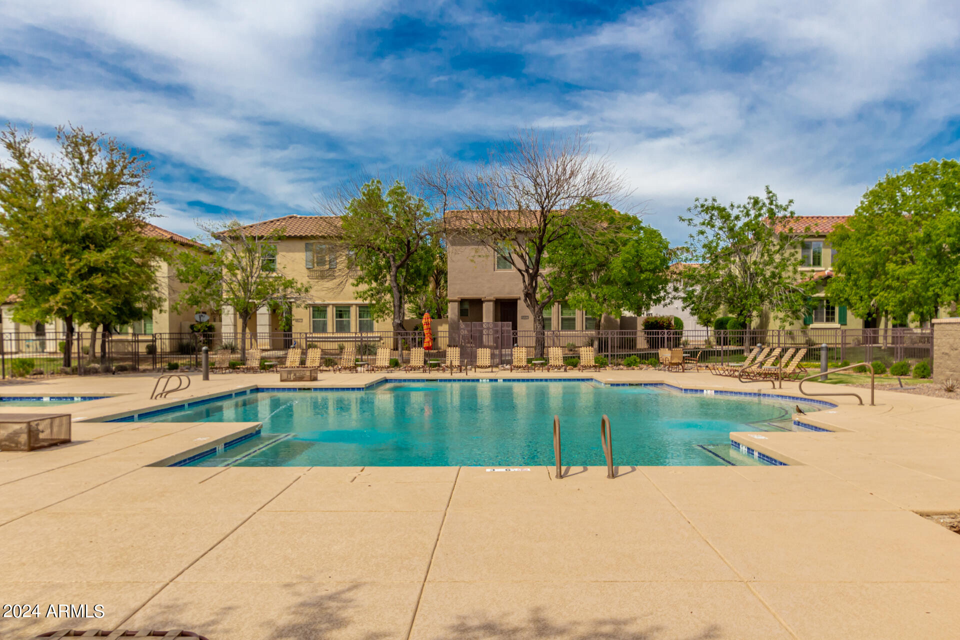 4333 South Rim Court Gilbert, AZ 85297 - Photo 56 of 77 a view of swimming pool with outdoor seating and house in the background