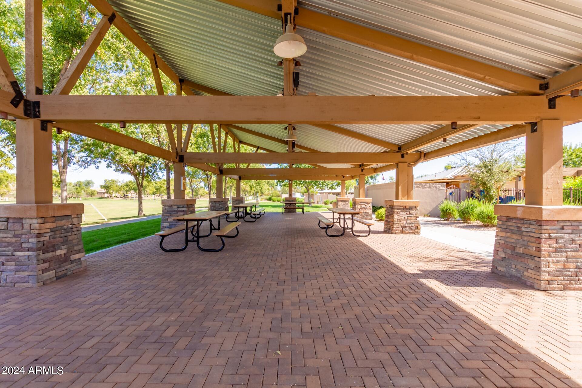 4333 South Rim Court Gilbert, AZ 85297 - Photo 68 of 77 a view of a patio with table and chairs a barbeque with wooden floor and roof