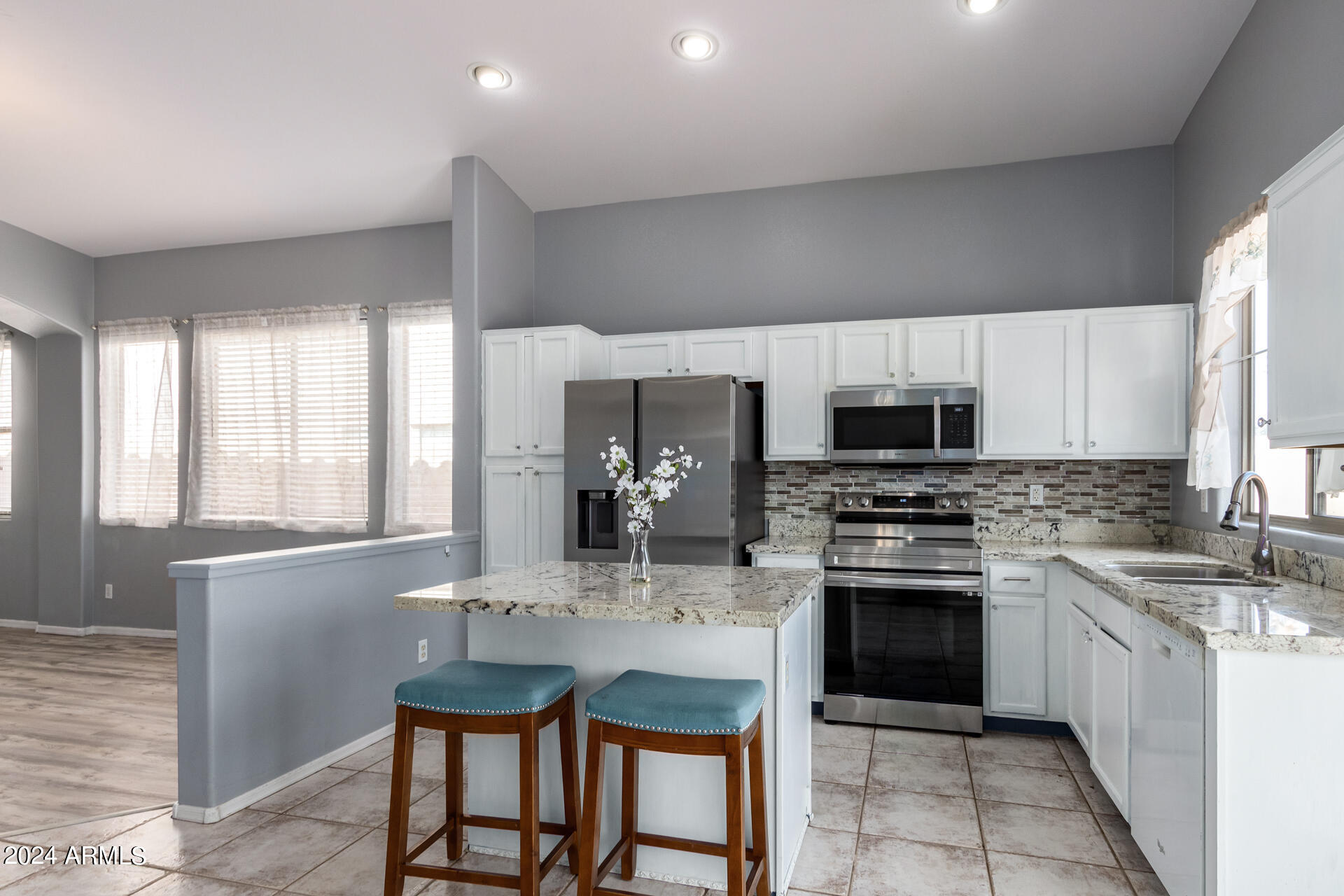 4333 South Rim Court Gilbert, AZ 85297 - Photo 10 of 77 a kitchen with stainless steel appliances granite countertop a stove refrigerator sink and cabinets