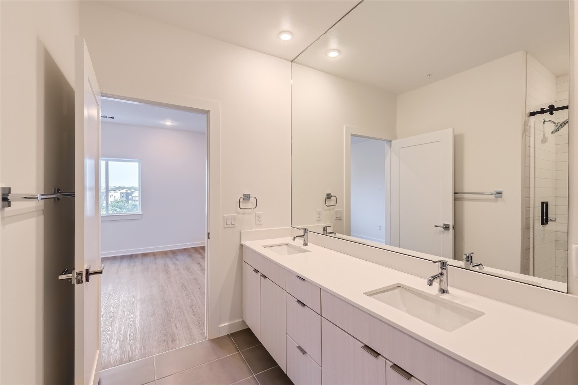 4802 South Congress Avenue, Unit 305 Austin, TX 78745 - Photo 18 of 25 a bathroom with double sink and a mirror