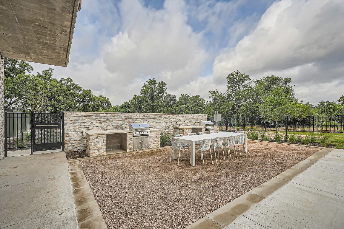 4802 South Congress Avenue, Unit 305 Austin, TX 78745 - Photo 21 of 25 a backyard of a house with table and chairs