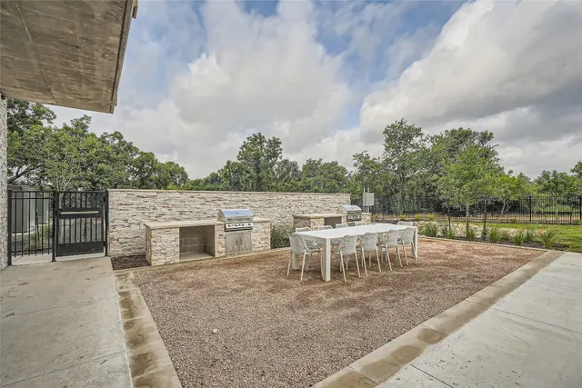 a backyard of a house with table and chairs