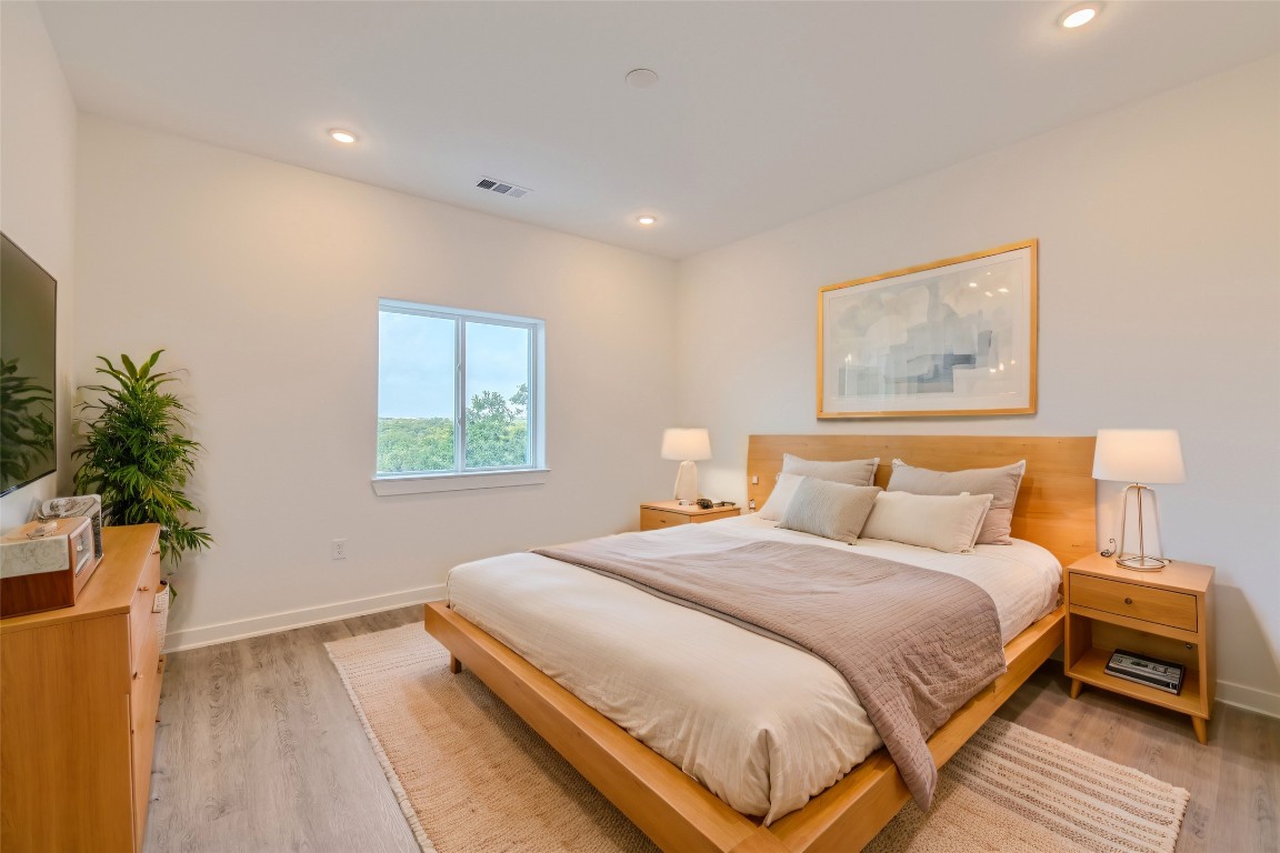 4802 South Congress Avenue, Unit 305 Austin, TX 78745 - Photo 6 of 25 a bedroom with a bed and a painting on the wall