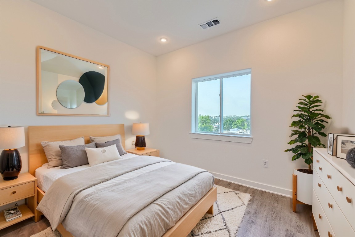 4802 South Congress Avenue, Unit 305 Austin, TX 78745 - Photo 10 of 25 a bedroom with a bed and a potted plant